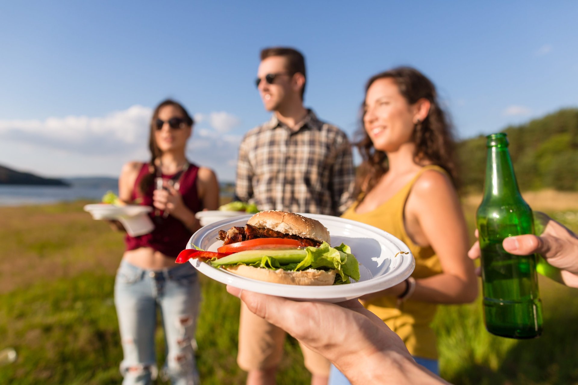 Friends eating at a summer barbeque outdoors