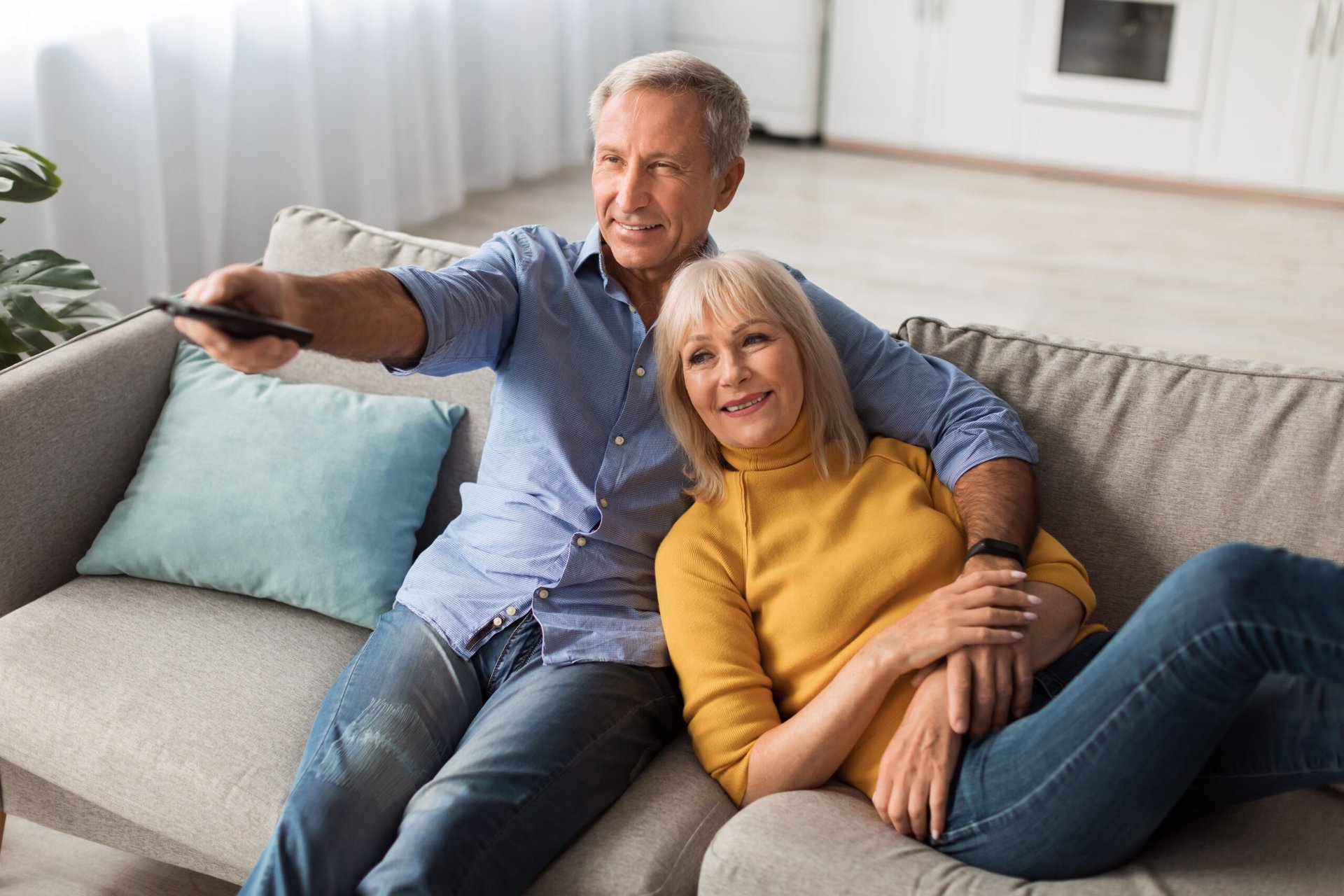 Older couple watching tv together.