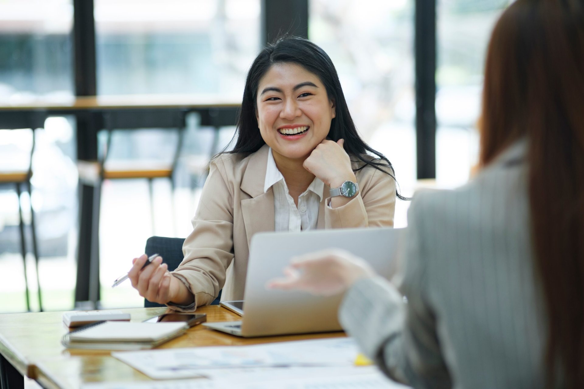 Two business professionals in a discussion or job interview in a modern office environment.