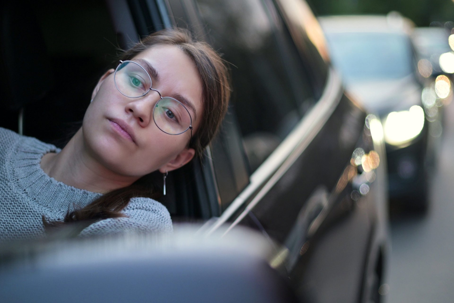 A woman bored and frustrated stuck in a traffic jam.