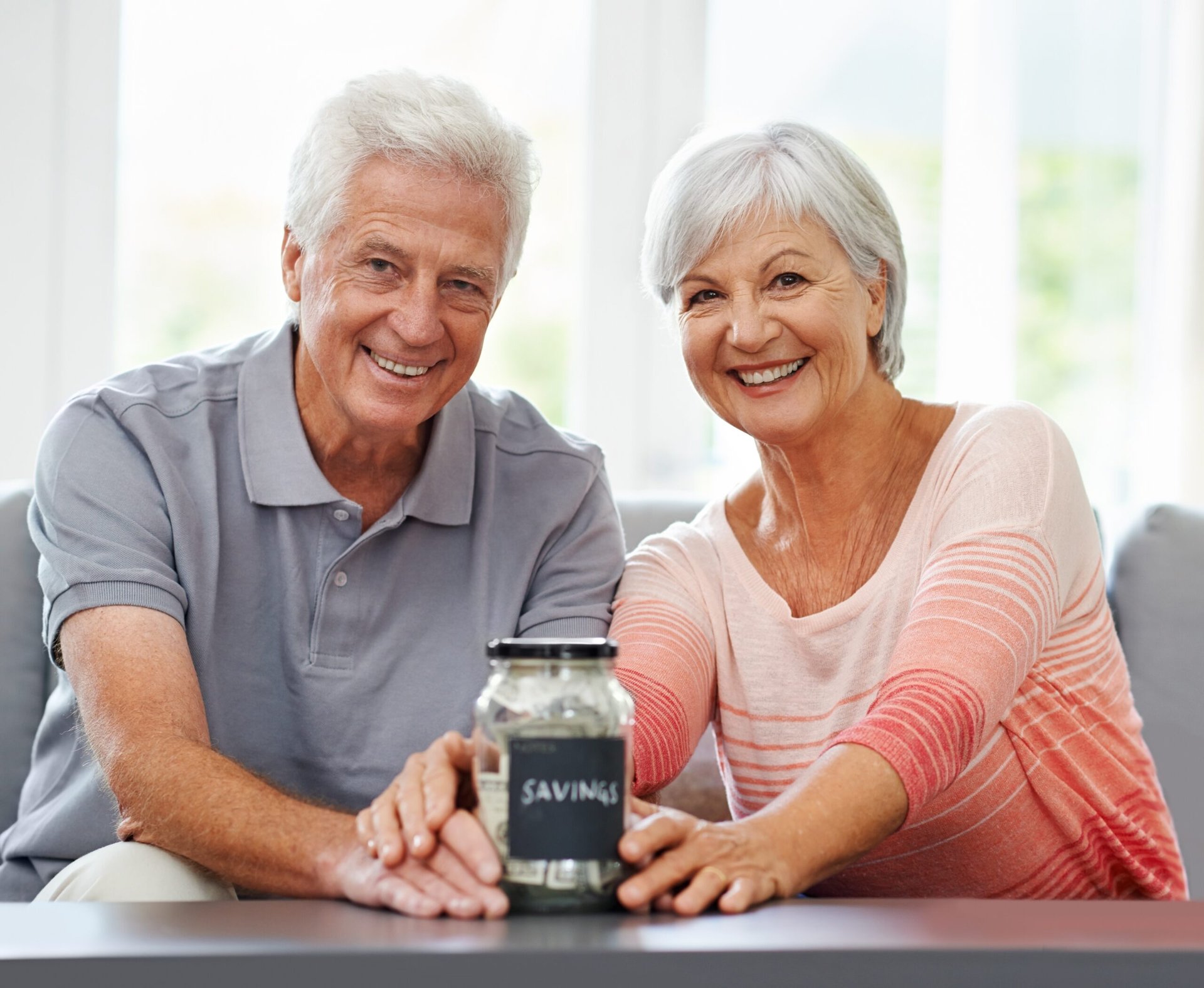 Older couple with a savings jar