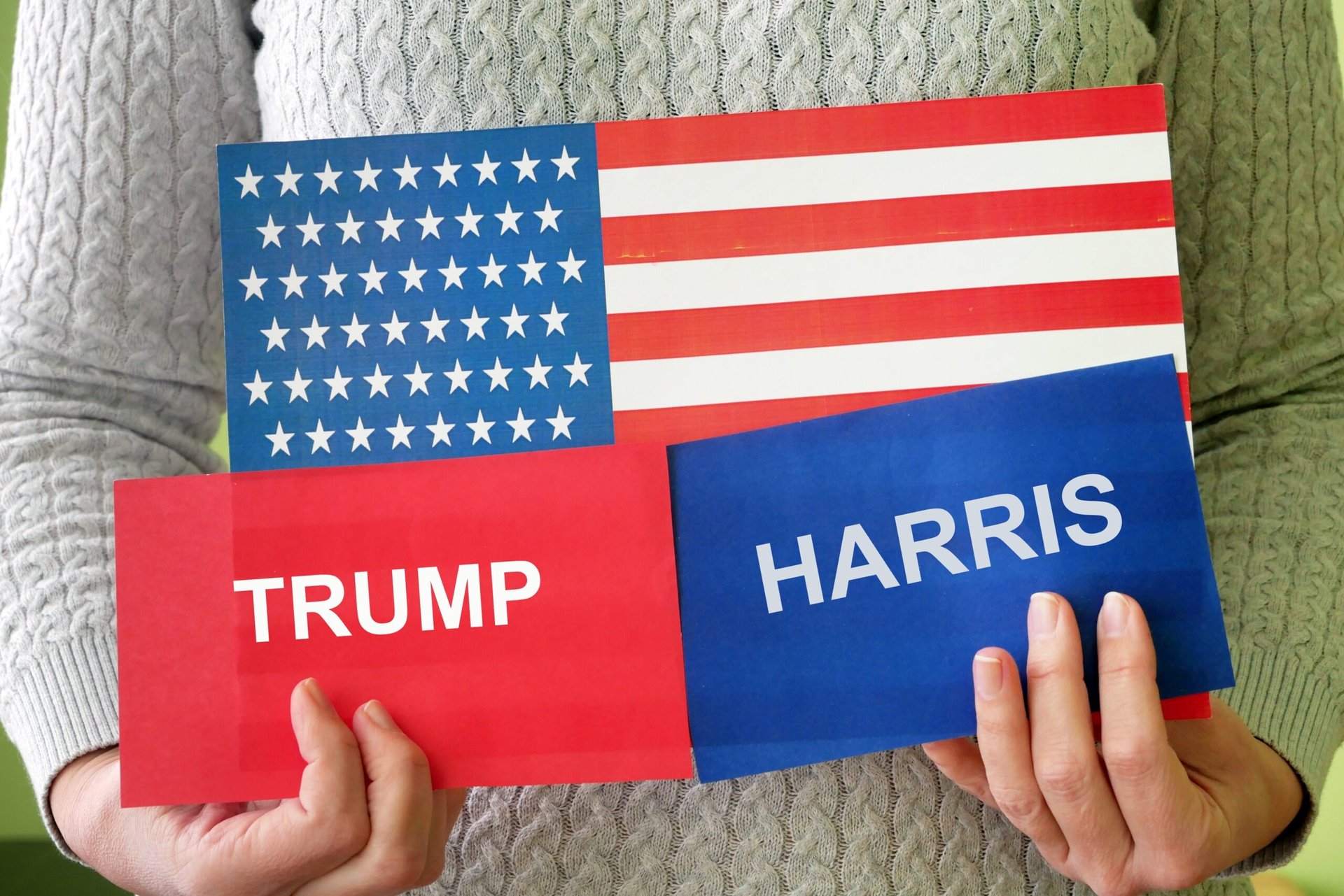 Trump and Harris cards on an American flag.