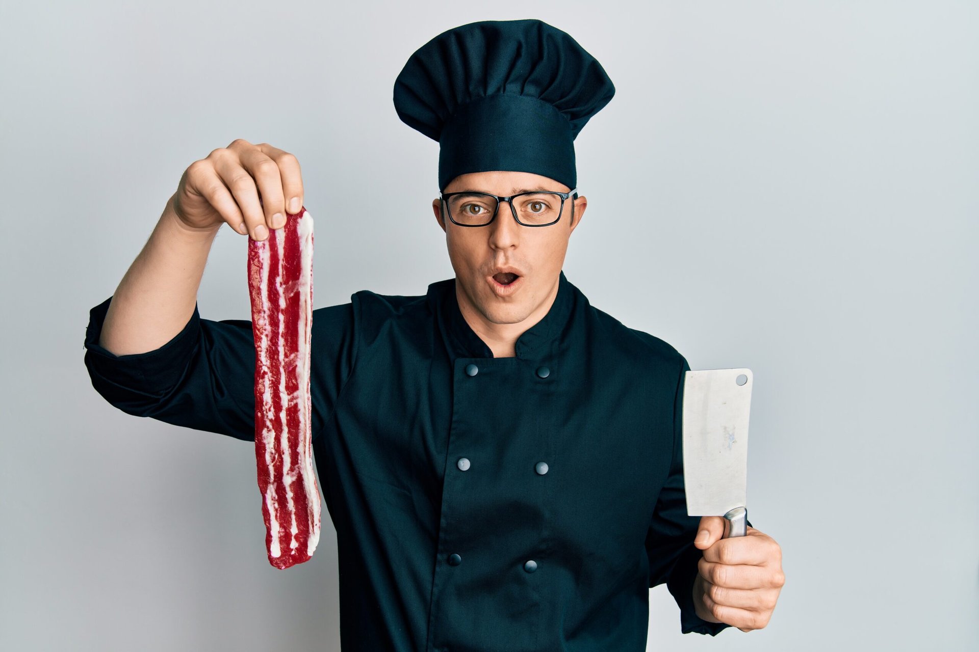 Chef with a strip of bacon