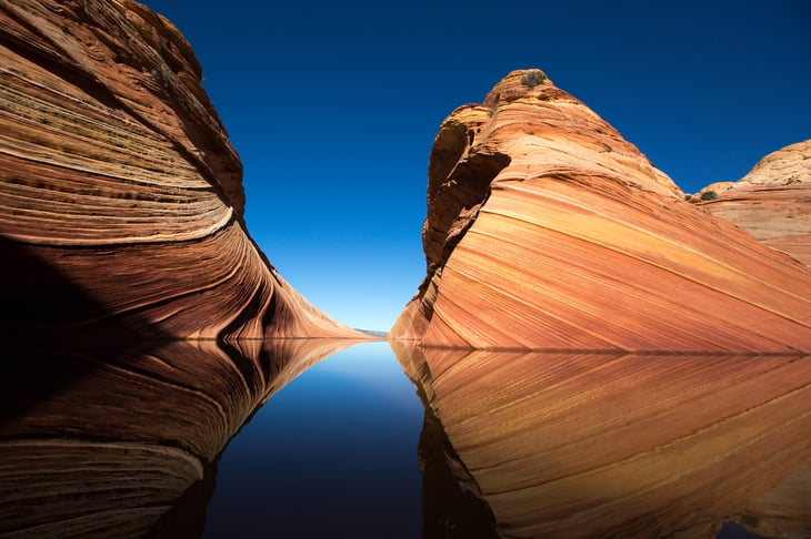 Cliffs reflecting in the water surface in the Wave, Arizona.
