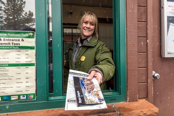 National Park Ranger hands out brochure through window at Bryce National Park, Utah