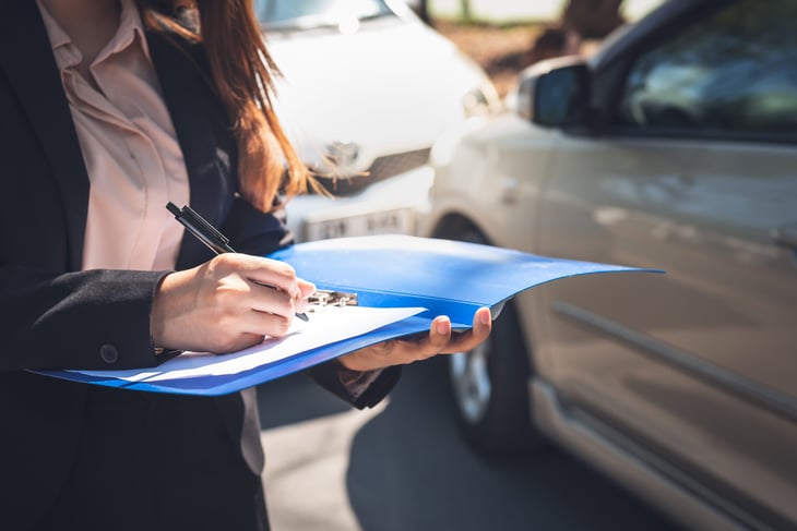 insurance agent recording information about car accident