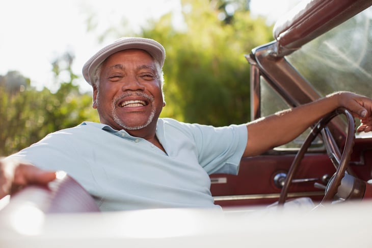 Happy retired man in his car