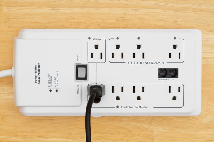 A power saving surge protector with power cord